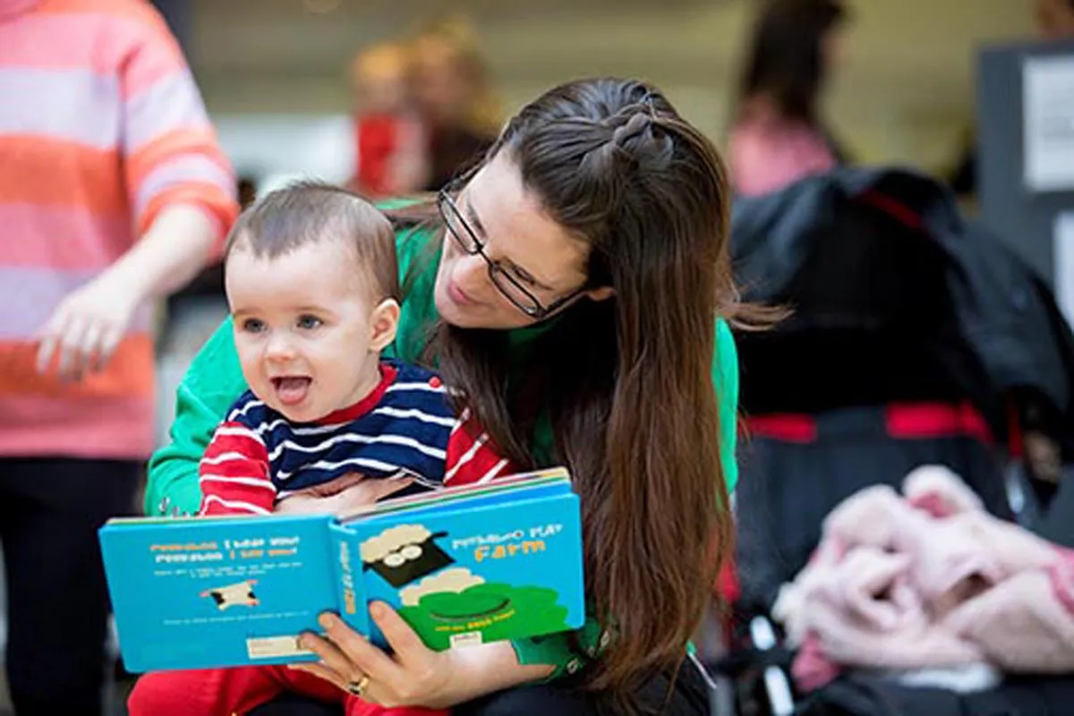 A mother reads to her daughter at the launch of a Dolly Parton imagination library