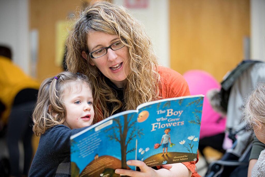 Mum reads a book from Dolly Parton's Imagination Library to her young child