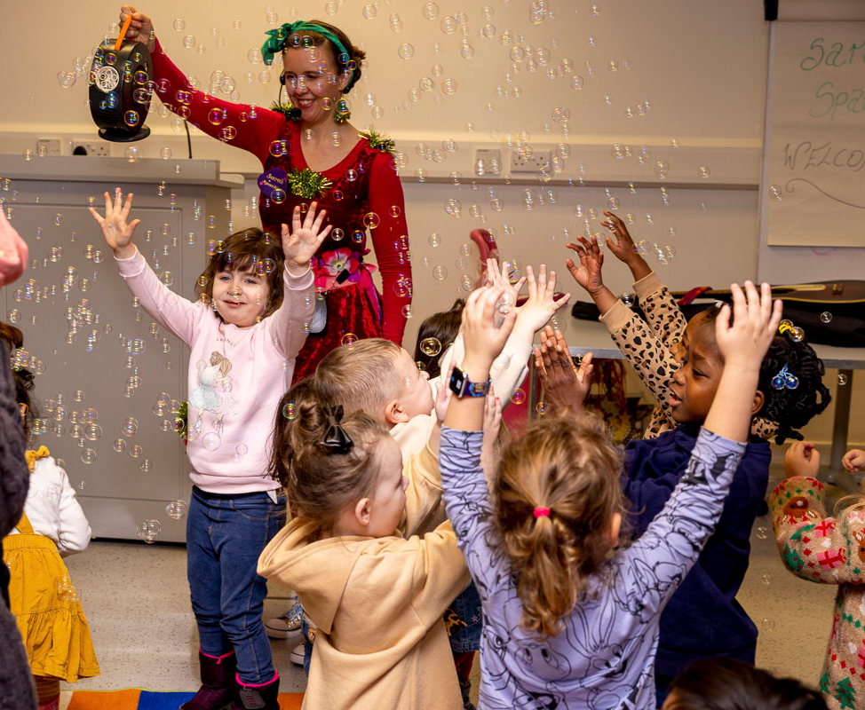 Sarah Sparkles children's entertainer, creates bubbles for happy childr